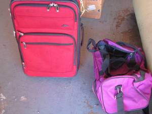 lot 158 image: Red luggage bag suitcase- pink gym bag