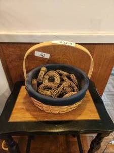 lot 232 image: Tasket basket full of rolls of basket making grapevine rolls