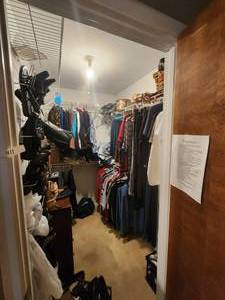 lot 410 image: Contents of Master bedroom closet - does not include shoes hanging on door