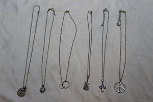lot 48 image: Several Silver in Color Necklaces with Pendants