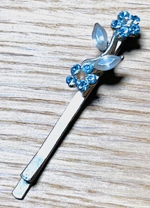 lot 72 image: SILVER TONE FLORAL HAIR CLIP WBLUE COLORED SWAROVSKI ACCENTS