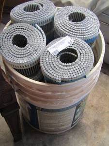 lot 45 image: 5 gallon bucket of nail strips in strips, approx. 10 rolls
