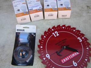 lot 77 image: Kohler toilet genuine parts, craftsman blade clock, 60 watt light bulbs qty 4