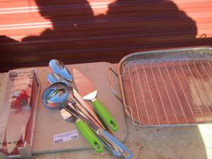 lot 104 image: High heel cake server, cutting boards, kitchen utensils