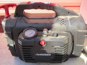 lot 2 image: Husky battery starter with outlet plug