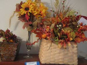 lot 22 image: Metal basket with fall greenery, clear vase with fall flowers, wooden wicker basket
