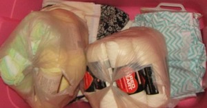 lot 36 image: Pink tote of new and used yarn plus patterns