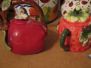 lot 129 image: red leaf handled tea pot, strawberry tea pot, lady bug tea pot