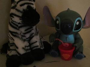 lot 144 image: kid lot- bubble blowing Stitch, plush zebra