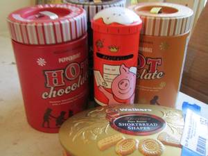 lot 152 image: Hot Cocoa tins and piglet tin can with candy coins ( DO NOT EAT CANDY DCOR ONLY)