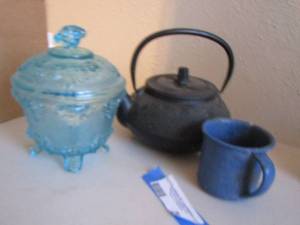 lot 209 image: Cast iron tea pot, blue speckled cup, blue press glass candy dish