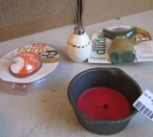 lot 212 image: Eggy egg timer, spud dude peeler, chick whisk, cast iron pot with candle