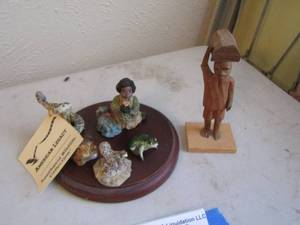 lot 214 image: Ceramic frogs ,Rattle Snake American legacy,   Carved Black Americana boy carrying a log