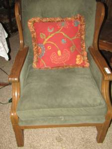lot 248 image: Green cushion chair with floral throw pillow