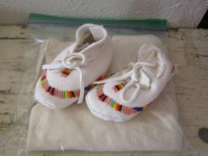 lot 315 image: Baby hand made moccasins and a fabric piece