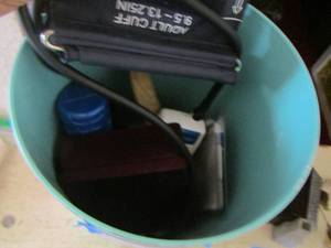 lot 317 image: Small waste basket- blood pressure cuff- kids water bottle- cook book