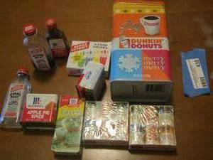 lot 435 image: mini bottles of seasoning, food coloring, coffee tin can