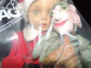 lot 602 image: Baby doll dressed in Santa suit, holding a gypsy lady