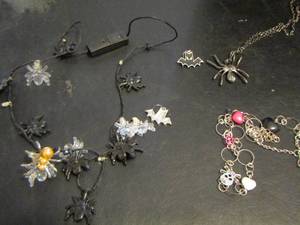 lot 823 image: LIGHTED SPIDER NECKLACE NEEDS BATTERIES, SPIDER NECKLACE AND A SKULL NECKLACE