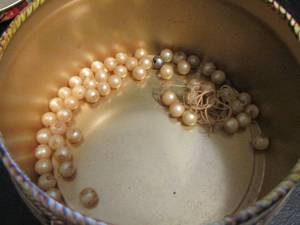 lot 864 image: APPLE TIN WITH PEARLS BEADS INSIDE