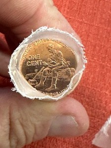 lot 913 image: ROLL OF PENNY -Young Abe reading a book while sitting on a log.  & A ROLL OF 2009 Penny Log Cabin  X $$