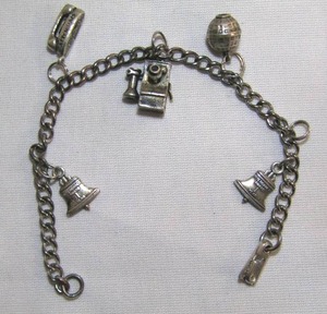 lot 90 image: Sterling silver Bell Telephone charm bracelet