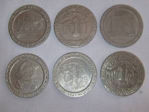 lot 36 image: Six retro casino tokens, including Reno Tahoe, Sheas, and others