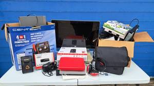 lot 60 image: Assorted electronics, including HP monitor, Netgear 2.4Ghz internet modem, portable DVD players, cables, Kodak camera, and more