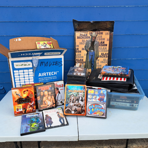 lot 80 image: Assorted DVDs, including The Beverly Hillbillies Collection DVD set, The Dukes of Hazzard Season One DVD, and other various DVDs, and Alan Jackson metal sign