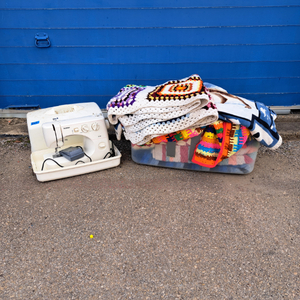 lot 79 image: Brother LS-30 sewing machine and various quilts and blankets