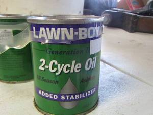lot 219 image: 2 cycle oil, 3 cans unopened lawn boy