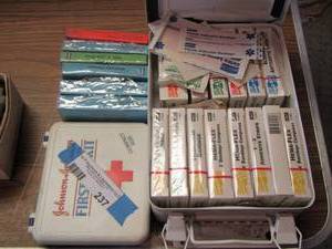 lot 237 image: First aid kits- various kinds of bandages and meds for stings and such