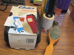 lot 242 image: Oster 11 piece pet hair cutting kit- lint roller- plus more