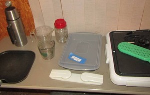 lot 592 image: Kitchen lot- griddle with plug- measuring cups- thermal- flat pan covered casserole dish