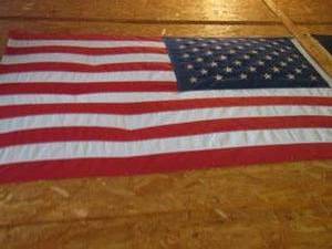 lot 598 image: 2 American flags size unknown unable to reach on ceiling