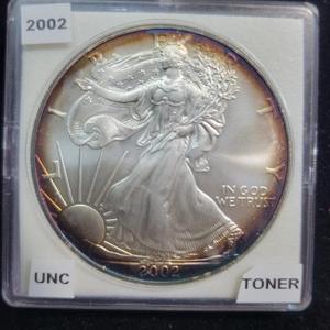 lot 4 image: 90 Percent Silver 2002 American Silver Eagle with Beautiful Toning