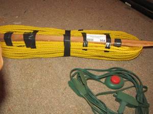 lot 954 image: roll of yellow nylon rope- green extension cord with push power button