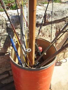 lot 1023 image: Various Reels and Fishing Poles IN  orange bucket , with rod stand