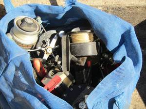 lot 1036 image: blue bag of used fishing reels - deep sea reels as well