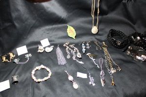 lot 202 image: (8) Purse dangles. Includes Rose Quartz dangle. Also includes belt selection, pewter Kentucky thimble, terra cotta items including perfume bottle necklace and sweater pin sets.