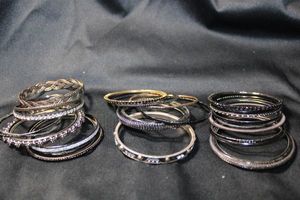 lot 223 image: (30) BLACK TONE metal, aluminum, and plastic bangle bracelets. Assorted styles.