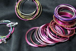 lot 219 image: (50) PINK and assorted color metal, aluminum and plastic bangle bracelets. Assorted styles.