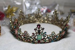 lot 238 image: SweeTV baroque style Bejeweled fashion metal Crown, matching Polki mogul style bangle with faux emeralds and rubies and Hair Accessory selection. Includes a pink barrette in gun form.