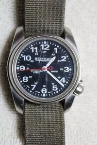 lot 201 image: Bertucci A-1S Field Comfort watch w camo green band. Ranges $60-125 on eBay. Some wear and scratches but the crystal is intact and clear.