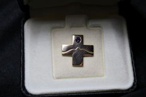 lot 21 image: 10K yellow gold filled cross tie tack by OC Tanner in box. Features an intaglio engraved dove and an Amethyst gem accent. Amethyst tested. Marked 110 10K.