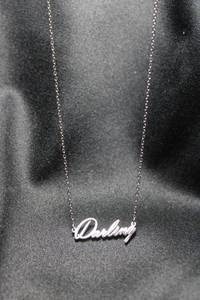 lot 28 image: Sterling Siler Darling word pendant necklace. Marked S925 on hang tag. 16L with a 2 extender.
