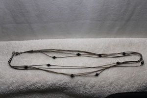 lot 151 image: Sterling Silver vintage 5-strand ball and tube bead necklace with onyx station beads. 18L. Marked sterling on cones near fish hook clasp. 6.3 gr approx