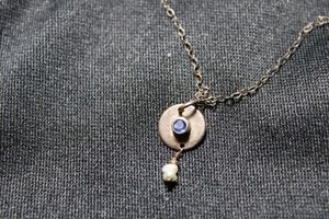 lot 13 image: Sterling Silver vintage disc pendant cable necklace with bezel set sapphire (tested) and freshwater pearl dangle. Marked 925 K M on reverse and on lobster clasp. 18L with 1 extender section. 2.0 gr approx