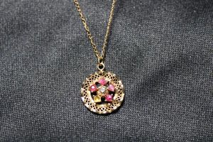 lot 41 image: 14K Gold Filled Diamond and Ruby pendant necklace. 19L. Diamonds and Rubies tested. Marked 14K GF D.E.C. on necklace and 120 14K GF D.E.C. on pendant. Missing 1 Ruby.