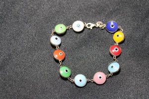 lot 48 image: Sterling Silver multi color glass Evil Eye bead station bracelet. Marked 925 on lobster clasp. 7L